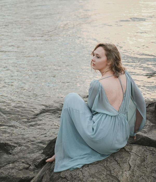A person in a calm, meditative pose in a tranquil natural setting.